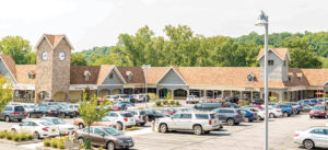CVS Pharmacy store exterior with customers and cars in the parking lot.