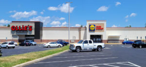 A large, mostly empty parking lot in front of a partially visible building with a "Hobby Lobby" sign.