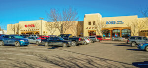 Shopping center with parking lot and several stores.