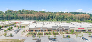 Aerial view of a strip mall with a large parking lot.