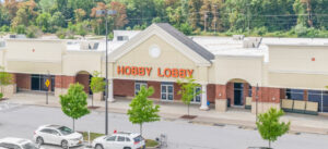 Exterior view of a retail building with "Goods" signage.