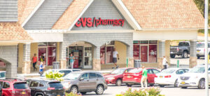 CVS Pharmacy storefront with cars in the parking lot.
