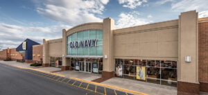 Exterior view of a strip mall with a GameStop store.