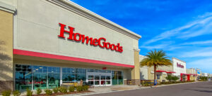 Row of storefronts under a bright blue sky.