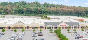 Exterior view of a Jazzercise fitness studio in a shopping center parking lot.